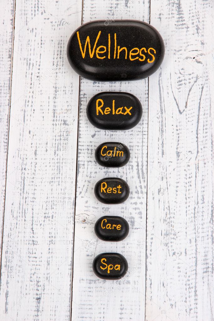 Spa stones on wooden background