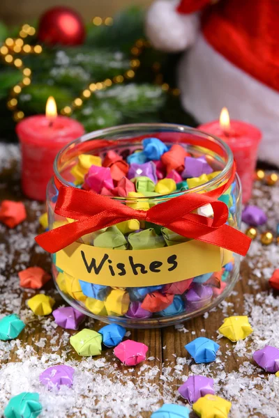 Paper stars with dreams in jar on table close-up — Stock Photo, Image