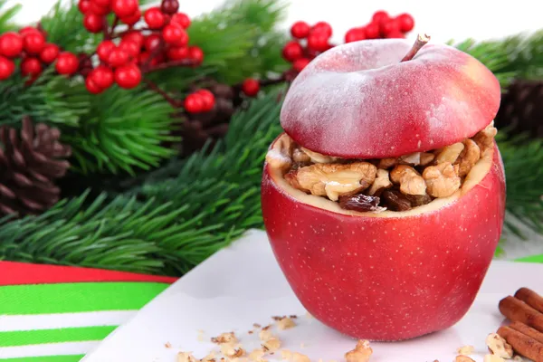 Stuffed Christmas apple with nuts and raisins on table close up — Stock Photo, Image