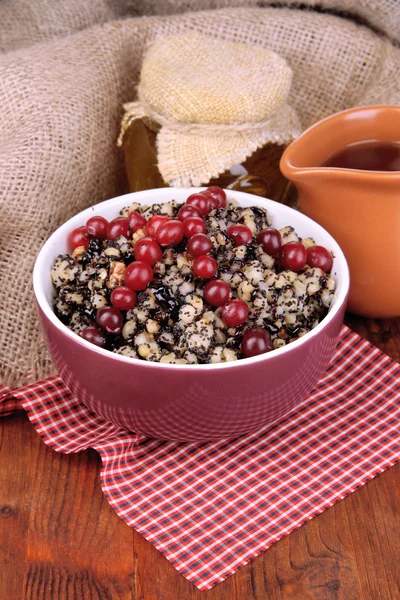 Bowl with kutia - traditional Christmas sweet meal in Ukraine, Belarus and Poland, on wooden background — Stock Photo, Image