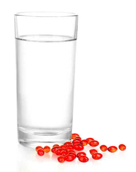 A glass of water and pills isolated on white close-up — Stock Photo, Image