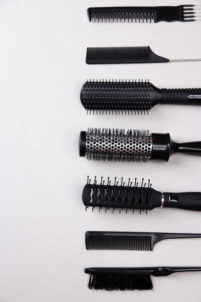 Black combs on gray background — Stock Photo, Image