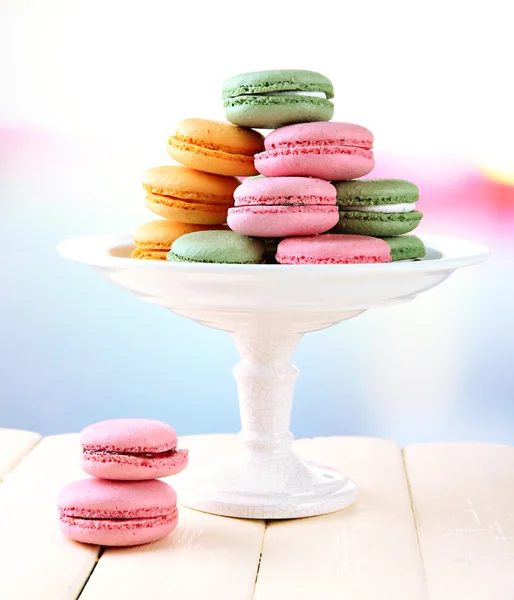 Gentle macaroons in vase on table on light background — Stock Photo, Image