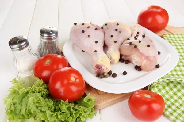 Raw chicken legs on plate close up — Stock Photo, Image