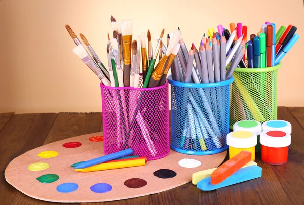 Composition of various creative tools on table on beige background — Stock Photo, Image