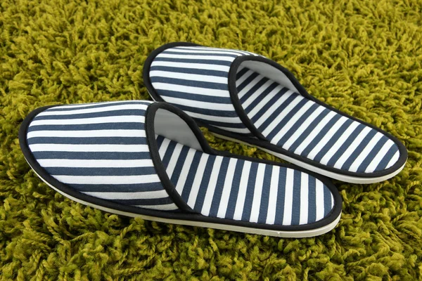 Striped slippers on carpet background — Stock Photo, Image