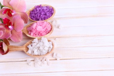 güzel çiçek ile natürmort orkide çiçek ve renk ahşap zemin üzerinde deniz tuzu ile tahta kaşıklar