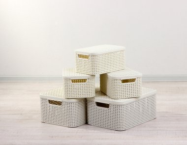 Plastic baskets for storing things in floor on room background clipart