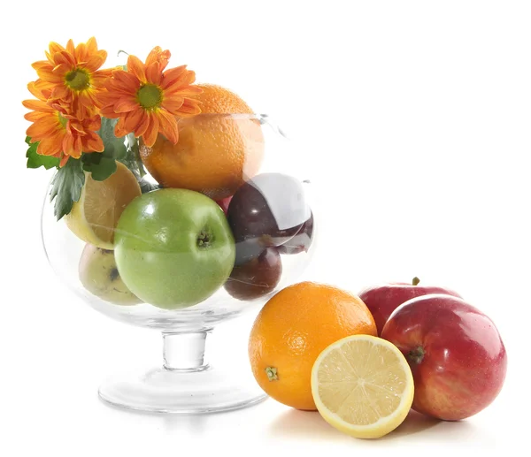 Koostumus eri hedelmiä lasi maljakko ja kukkia eristetty valkoinen — kuvapankkivalokuva