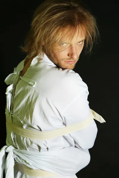 Mentally ill man in strait-jacket on black background — Stock Photo, Image