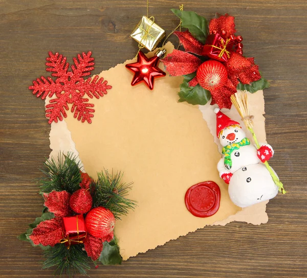 Marco con papel vintage y decoraciones navideñas sobre fondo de madera — Foto de Stock