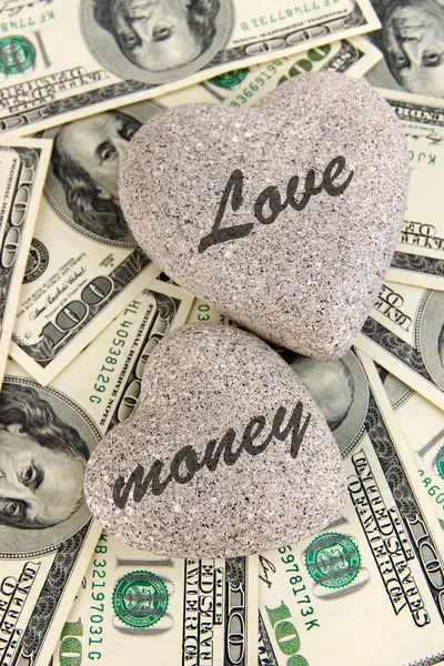 Love and money concept. Heart-shaped stone and American currency close up. — Stock Photo, Image