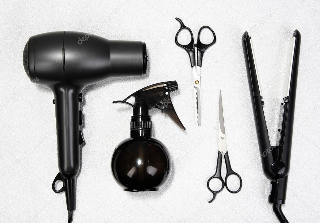 Hairdressing tools on silver background