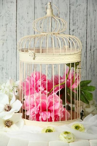 Beautiful decorative cage with beautiful flowers — Stock Photo, Image