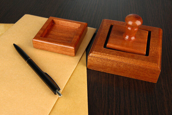 Деревянная печать с документами на столе
