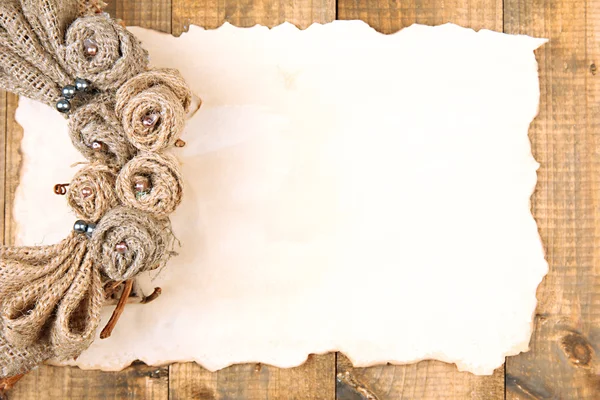 Old paper sheet and beautiful rustic wreath, on wooden background — Stock Photo, Image