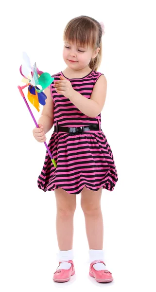 Güzel küçük bir kız üzerinde beyaz izole renkli rüzgar türbini holding — Stok fotoğraf