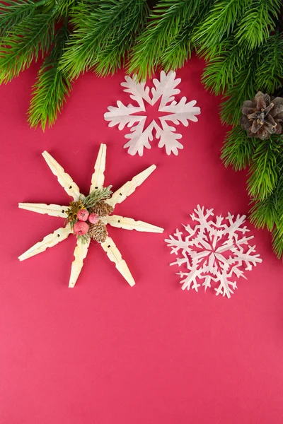 Bellissimi fiocchi di neve con ramo di abete su sfondo rosa — Foto Stock