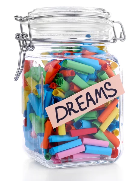 Dromen geschreven op kleur papier gerold in glazen pot, geïsoleerd op wit — Stockfoto
