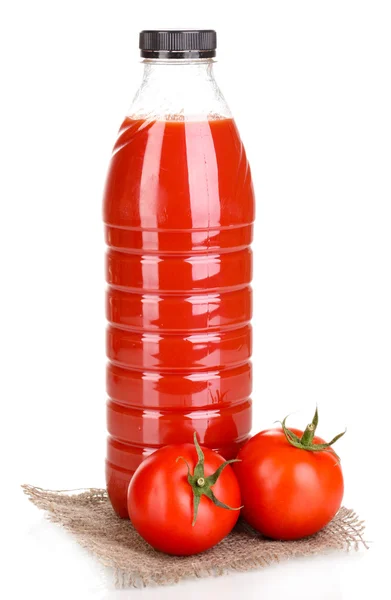 Tomato juice in bottle on sackcloth isolated on white — Stock Photo, Image