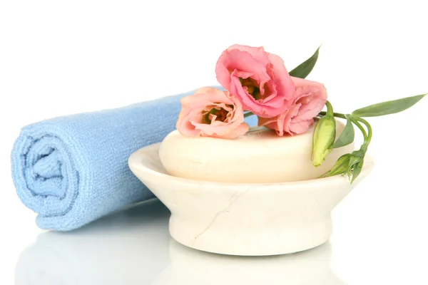 Rolled blue towel, soap bar and beautiful flower isolated on white — Stock Photo, Image