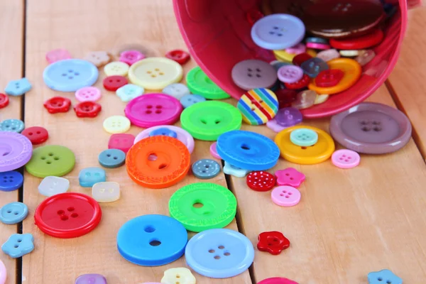 Colorful buttons strewn from bucket close-up — Stock Photo, Image