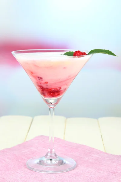 Raspberry milk dessert in cocktail glass, on light background — Stock Photo, Image