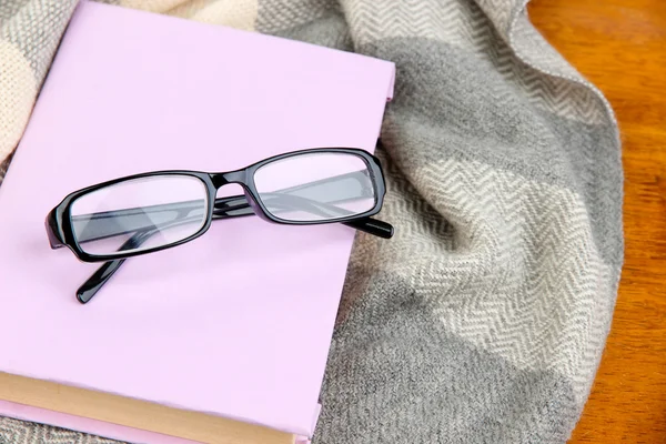 Composition with old book, eye glasses and plaid on wooden background — Stock Photo, Image