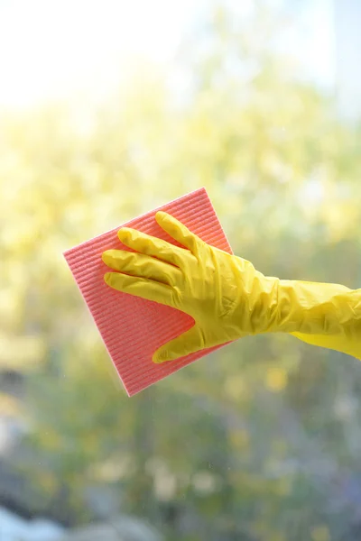 Hands with napkin cleaning window — Stock Photo, Image