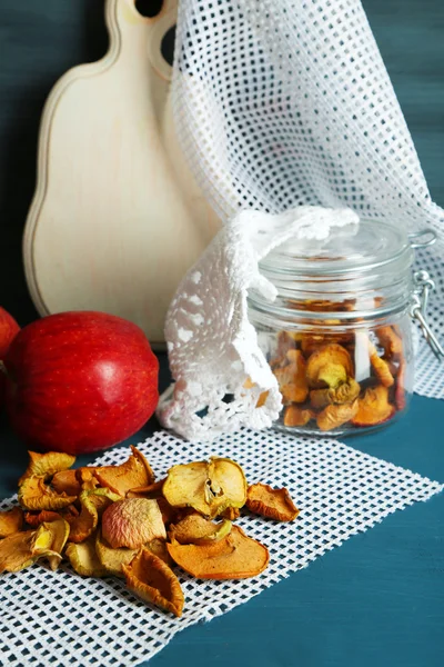 Dried apples in glass jar, on color wooden background — Stock Photo, Image