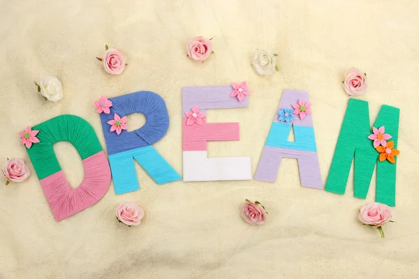 Word Dream created with brightly colored knitting yard on fabric background — Stock Photo, Image