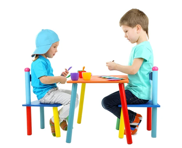 Little children playing with colorful tableware isolated on white — Stock Photo, Image