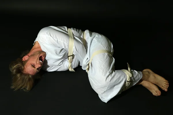 stock image Mentally ill man in strait-jacket on black background