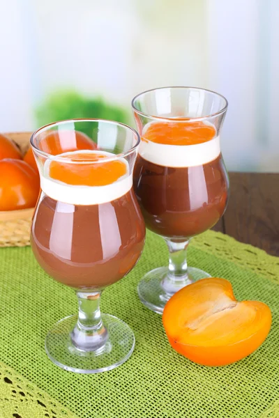 Dessert of chocolate and persimmon on table on light background — Stock Photo, Image