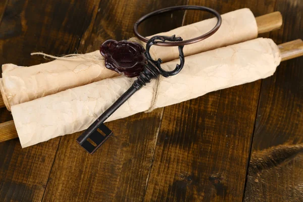 Antique keys and scroll, on wooden background — Stock Photo, Image