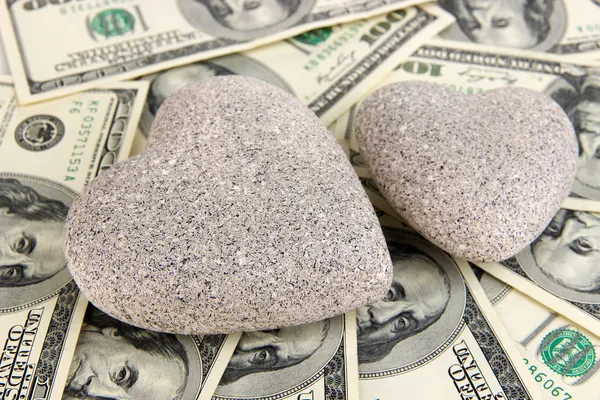 Love and money concept. Heart-shaped stone and American currency close up. — Stock Photo, Image