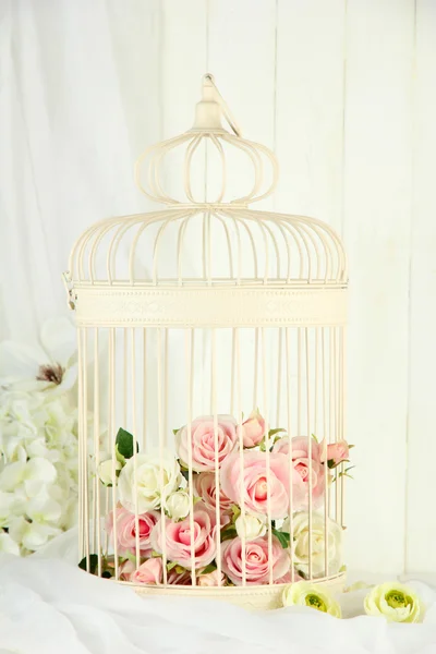 Beautiful decorative cage with beautiful flowers — Stock Photo, Image