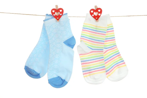 Socks hanging on clothesline isolated on white — Stock Photo, Image