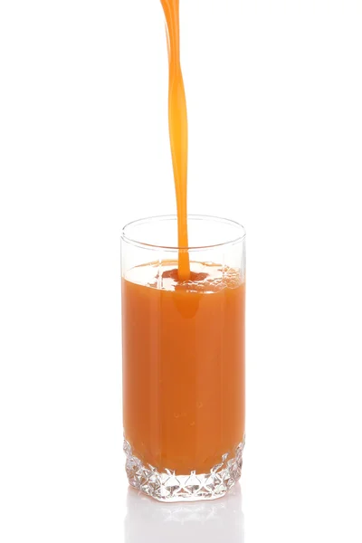 Juice pouring into glass isolated on white — Stock Photo, Image