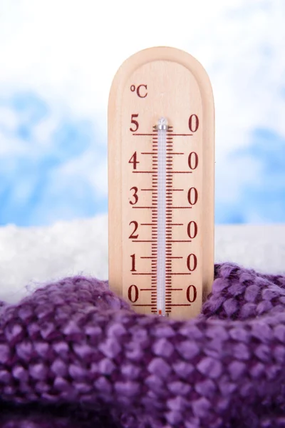 Thermometer in snow on light background — Stock Photo, Image