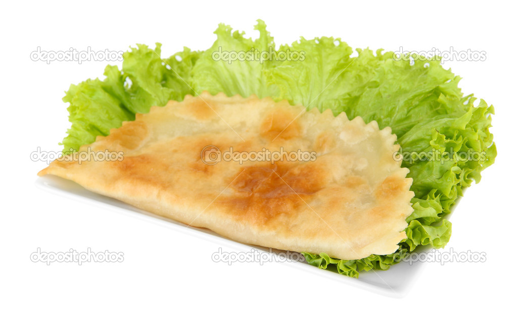 Tasty cheburek with fresh herbs on plate,isolated on white
