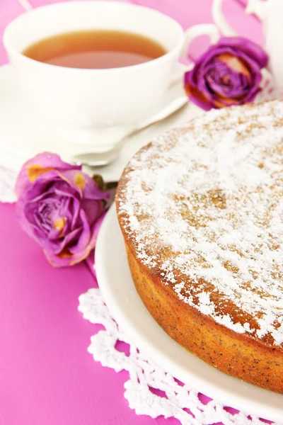 Delicious poppy seed cake with cup of tea on table close-up — Stock Photo, Image