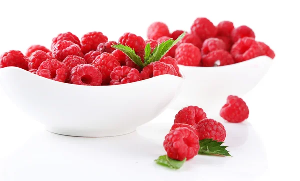 Ripe sweet raspberries in bowls, isolated on white — Stock Photo, Image