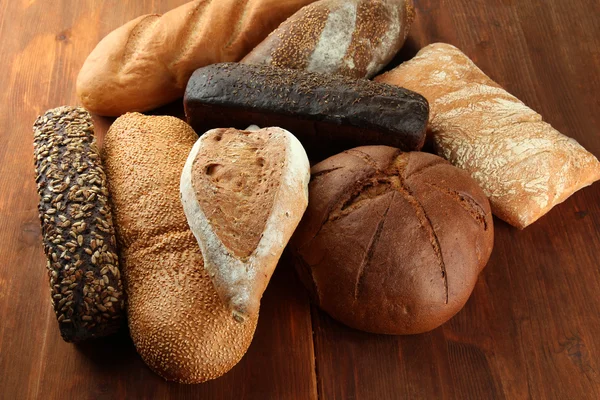 Much bread on wooden board — Stock Photo, Image