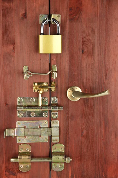 Metal bolts, latches and hooks in wooden door close-up — Stock Photo, Image