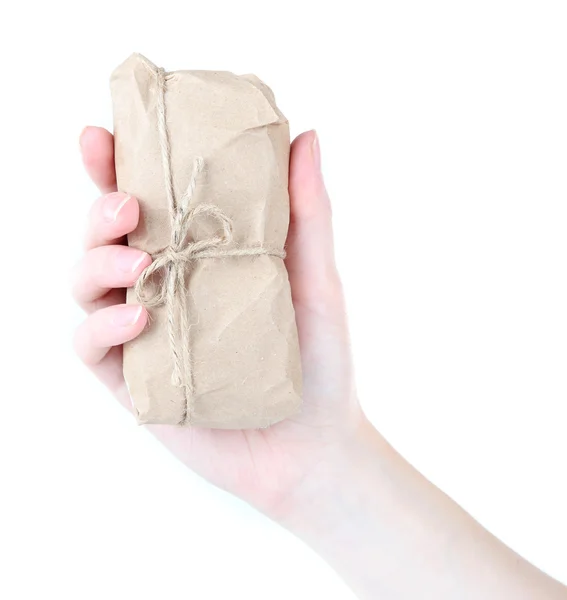 Nő kezében csomagolva barna nátronpapirból, elszigetelt fehér telefon — Stock Fotó