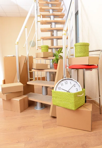 Stack of cartons near stairs: moving house concept — Stock Photo, Image