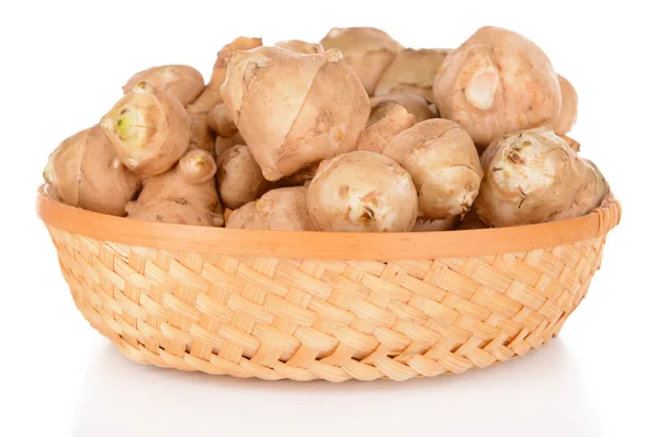 Topinambur roots in wicker basket isolated on white — Stock Photo, Image