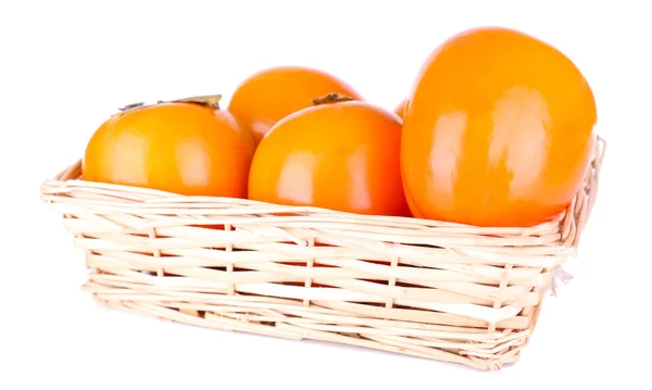 Ripe persimmons in wicker basket isolated on white — Stock Photo, Image