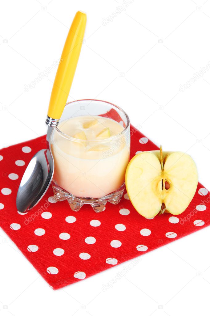 Delicious yogurt in glass with apple isolated on white
